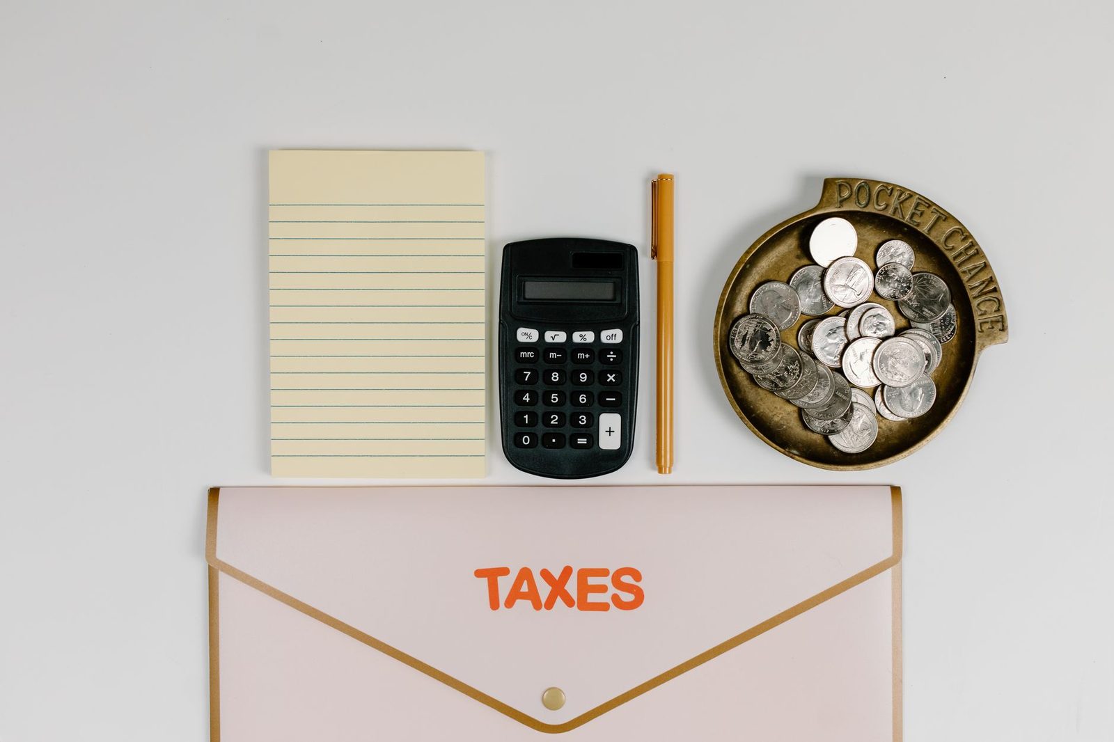 Calculadora, moedas e envelope, remetendo ao cálculo do valor do benefício